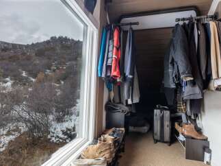 This cozy space features a well-organized closet, perfect for storing your wardrobe.
