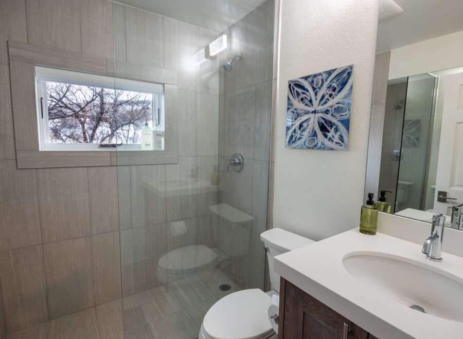 Step into a beautifully designed bathroom featuring a modern glass shower and stylish tile work.
