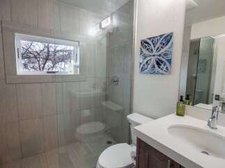 Step into a beautifully designed bathroom featuring a modern glass shower and stylish tile work.