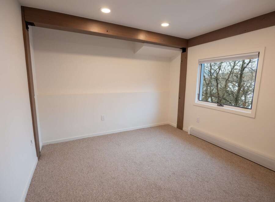 This inviting room features a neutral color palette, creating a versatile space ready for your personal touch.