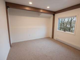 This inviting room features a neutral color palette, creating a versatile space ready for your personal touch.