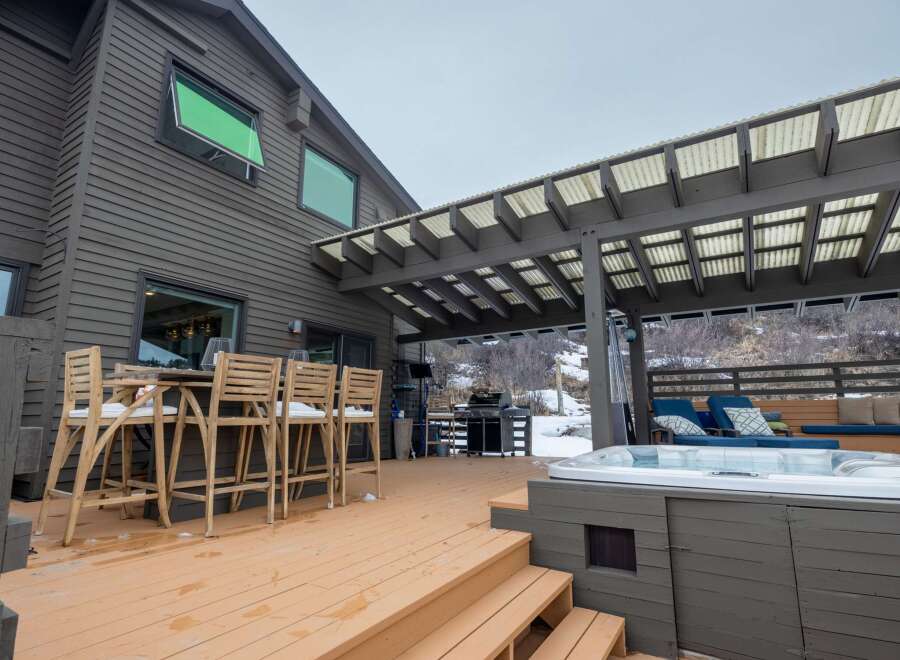 Enjoy outdoor living at its finest with this stunning property featuring a spacious deck and a luxurious hot tub.