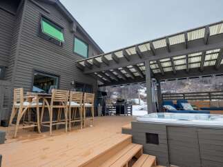 Enjoy outdoor living at its finest with this stunning property featuring a spacious deck and a luxurious hot tub.