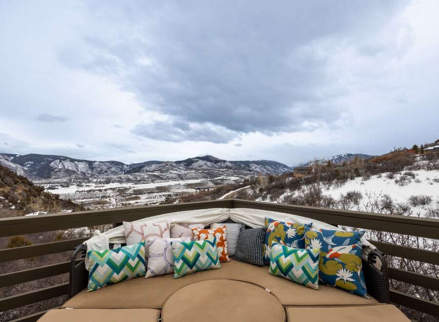 Enjoy breathtaking mountain views from this luxurious outdoor seating area.
