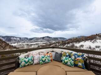 Enjoy breathtaking mountain views from this luxurious outdoor seating area.