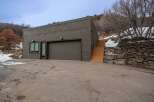 This modern property features a sleek, contemporary design with a spacious garage and a welcoming entrance.