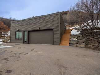 This modern property features a sleek, contemporary design with a spacious garage and a welcoming entrance.