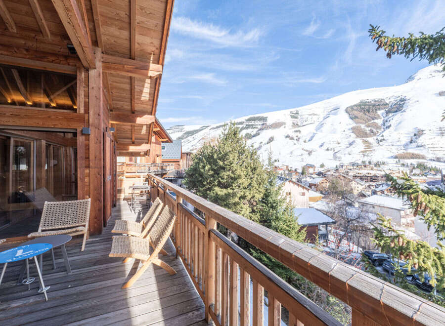 Experience breathtaking mountain views from this charming wooden balcony, perfect for enjoying your morning coffee or evening wine.