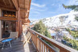 Experience breathtaking mountain views from this charming wooden balcony, perfect for enjoying your morning coffee or evening wine.