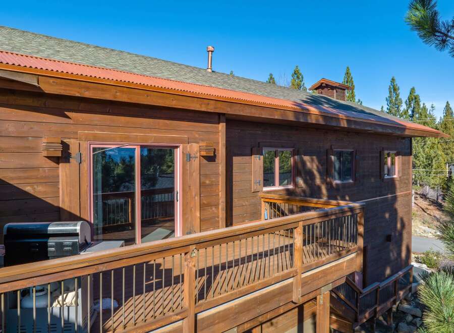This stunning property boasts a beautiful wooden exterior and a spacious deck, perfect for enjoying the outdoors.