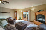 Step into a cozy living space with a beautiful fireplace and a sliding door that leads to a deck.