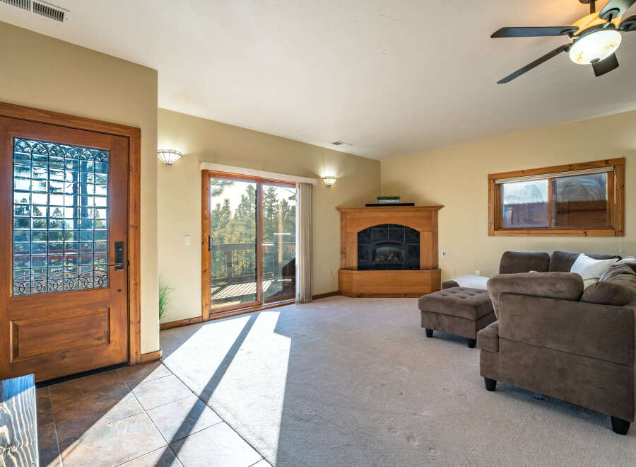 Step into this inviting living space, featuring a cozy fireplace and ample natural light.