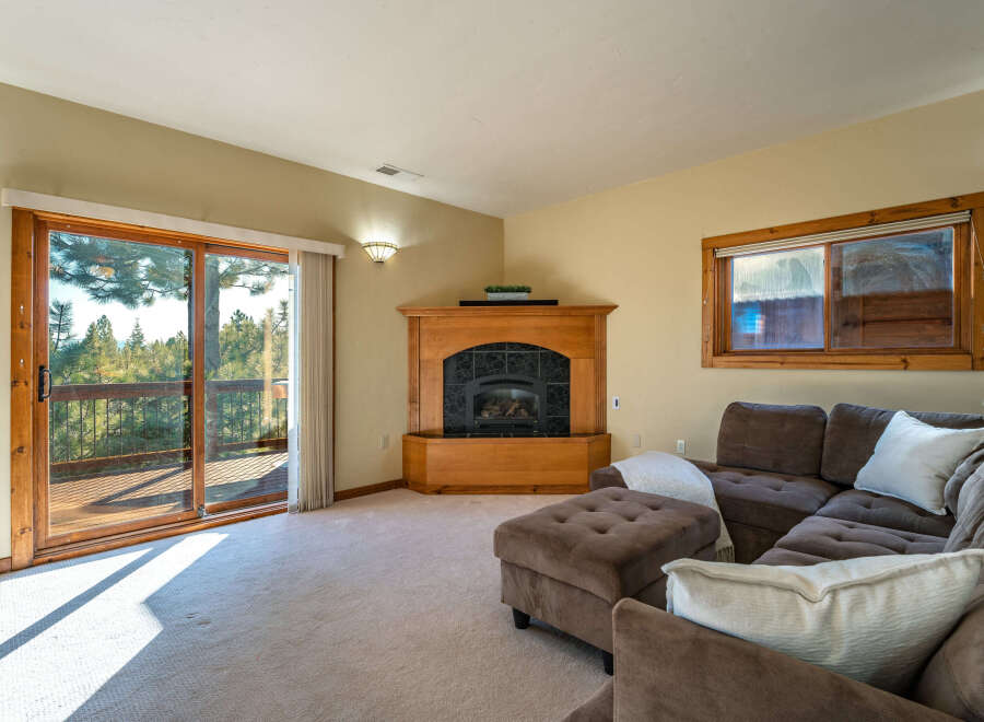 This stunning living room boasts a cozy fireplace and a comfortable sectional sofa, perfect for relaxing evenings.