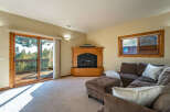 This stunning living room boasts a cozy fireplace and a comfortable sectional sofa, perfect for relaxing evenings.