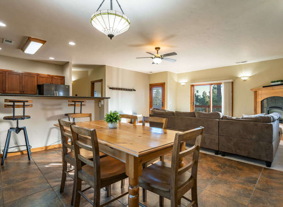 This inviting living space features a cozy dining area with a wooden table and chairs, perfect for gatherings.