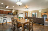 This inviting living space features a cozy dining area with a wooden table and chairs, perfect for gatherings.