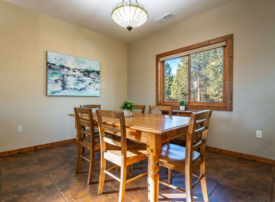 This inviting dining area features a beautiful wooden table and chairs, perfect for family gatherings.