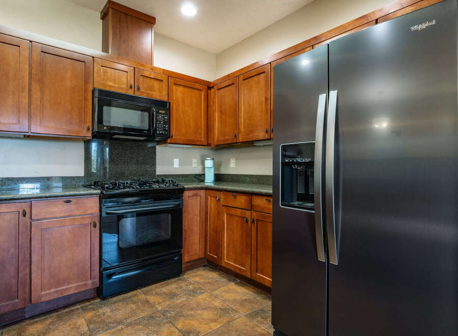 This stunning kitchen boasts beautiful wooden cabinetry, offering ample storage and a warm, inviting atmosphere.