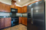 This stunning kitchen boasts beautiful wooden cabinetry, offering ample storage and a warm, inviting atmosphere.