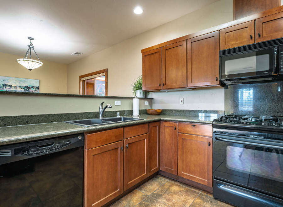 This stunning kitchen boasts beautiful wooden cabinetry, offering ample storage and a warm, inviting atmosphere.
