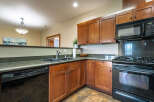 This stunning kitchen boasts beautiful wooden cabinetry, offering ample storage and a warm, inviting atmosphere.