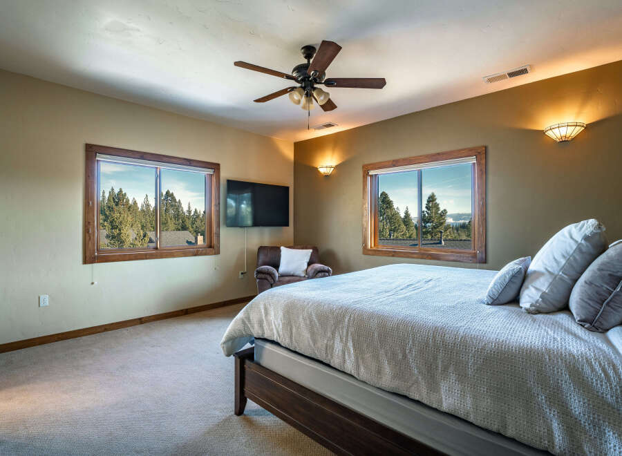 This inviting bedroom features a comfortable bed with plush pillows, perfect for relaxation.