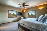 This inviting bedroom features a comfortable bed with plush pillows, perfect for relaxation.