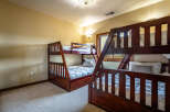 This cozy bedroom features two sets of bunk beds, perfect for accommodating multiple guests or family members.