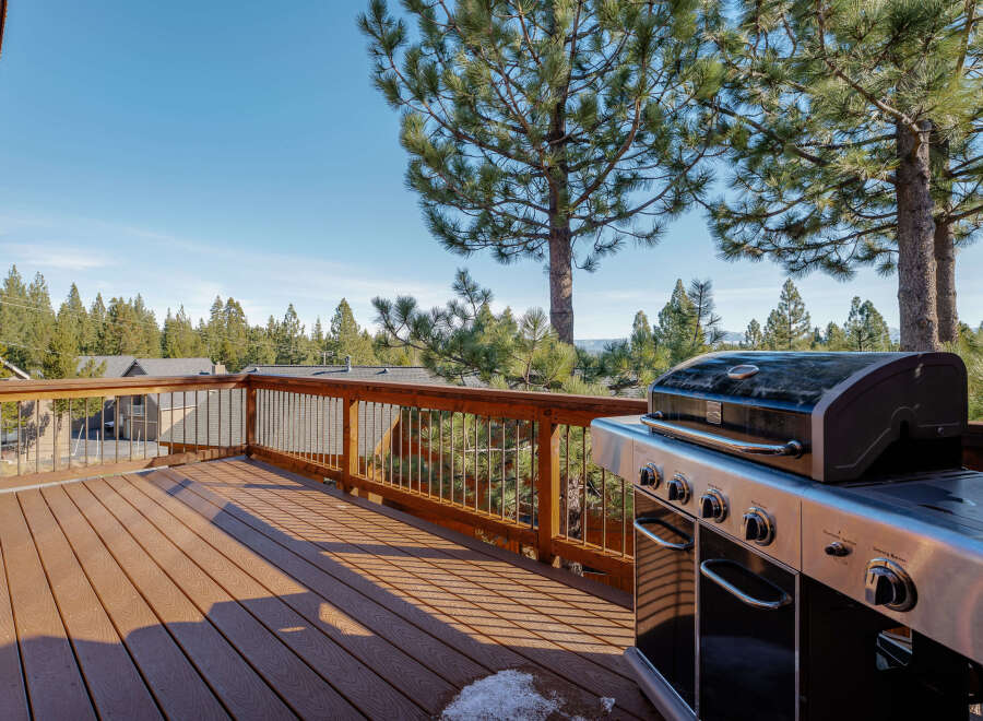 Enjoy outdoor living at its finest with this stunning property featuring a spacious deck and a high-end grill.