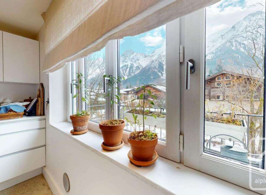 Enjoy breathtaking mountain views from this charming kitchen.
