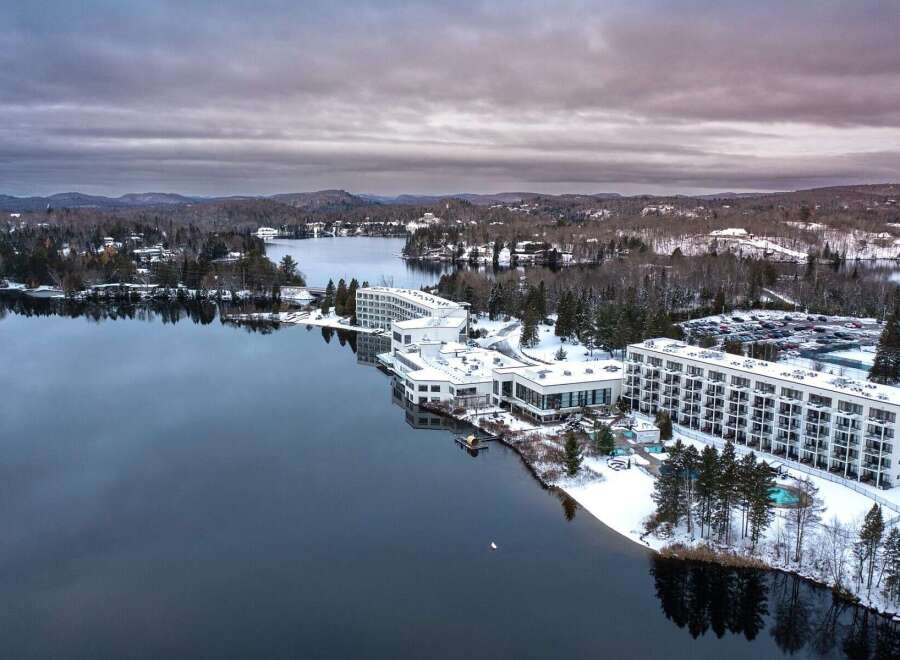 Discover a stunning waterfront property nestled amidst a serene winter landscape.