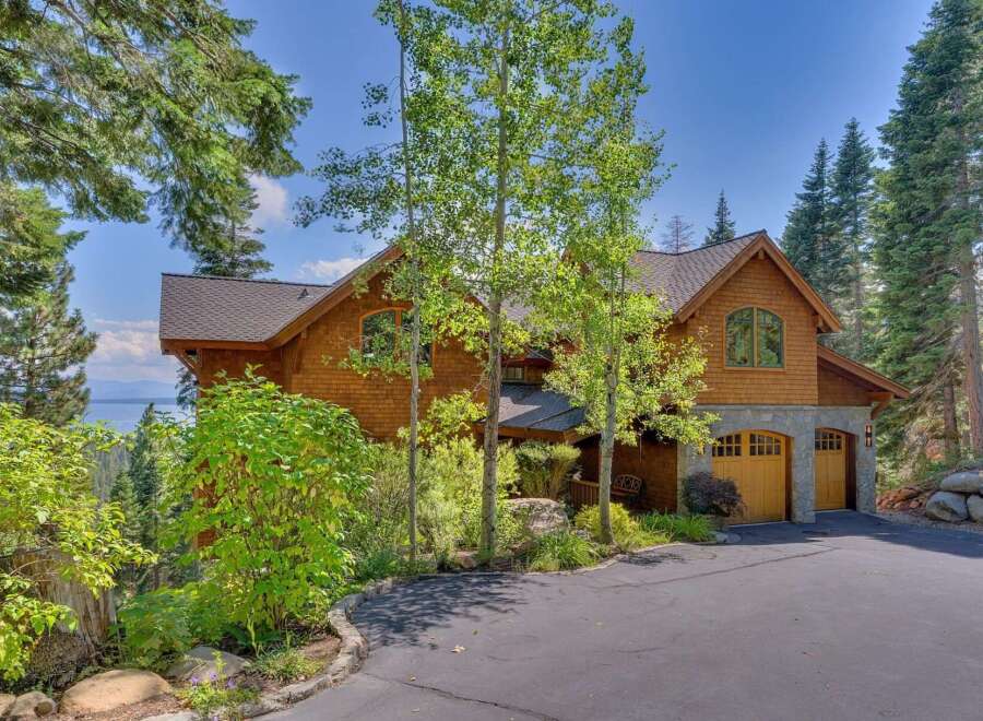 Nestled amidst lush greenery and towering trees, this stunning property offers a serene escape.