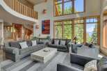 Experience luxury living in this stunning property, featuring a grand living room with soaring ceilings and expansive windows that frame breathtaking views.