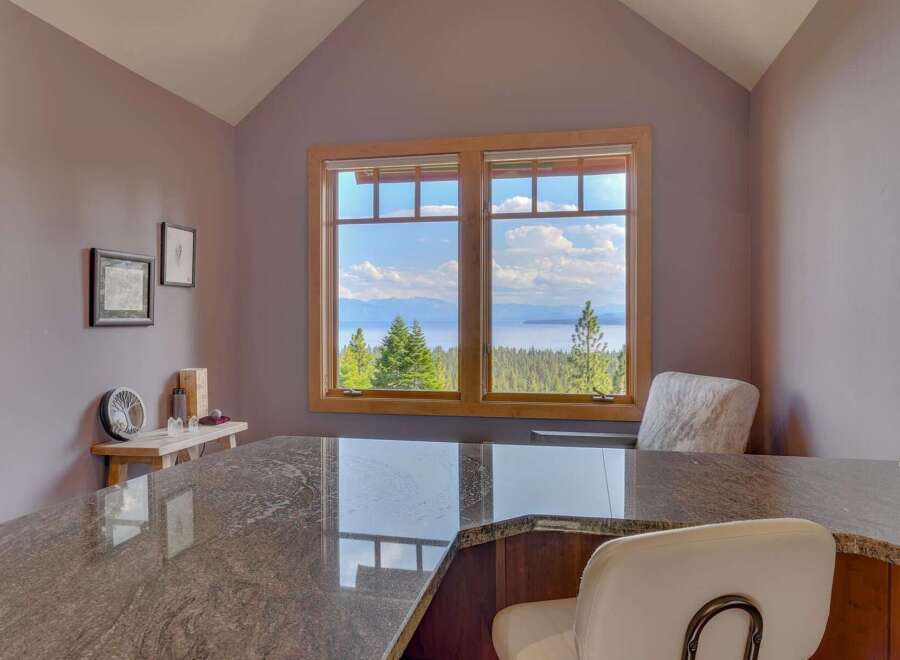 Enjoy breathtaking views from this stunning property! This home features a beautiful kitchen with a granite countertop and a cozy seating area.