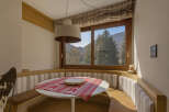 This charming dining nook offers a cozy space for meals with a view.