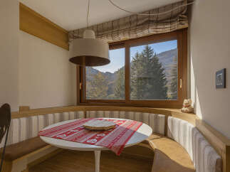 This charming dining nook offers a cozy space for meals with a view.
