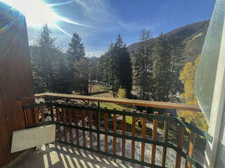 Enjoy breathtaking mountain views from this charming balcony.