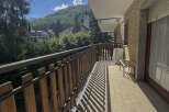 Enjoy breathtaking mountain views from this charming balcony.