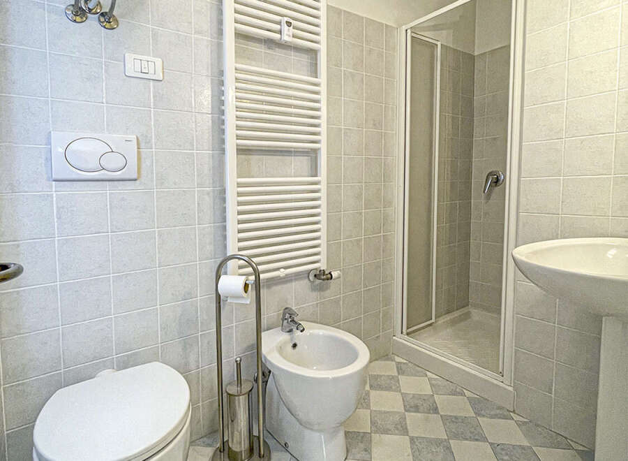 Step into this bright and airy bathroom, featuring a modern design and essential amenities.
