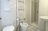Step into this bright and airy bathroom, featuring a modern design and essential amenities.