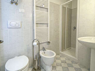 Step into this bright and airy bathroom, featuring a modern design and essential amenities.