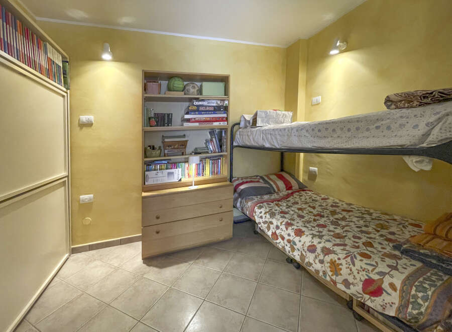 This cozy bedroom features a bunk bed, perfect for maximizing space.
