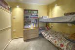This cozy bedroom features a bunk bed, perfect for maximizing space.