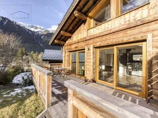 Experience the charm of this stunning wooden chalet nestled in a picturesque mountain setting.