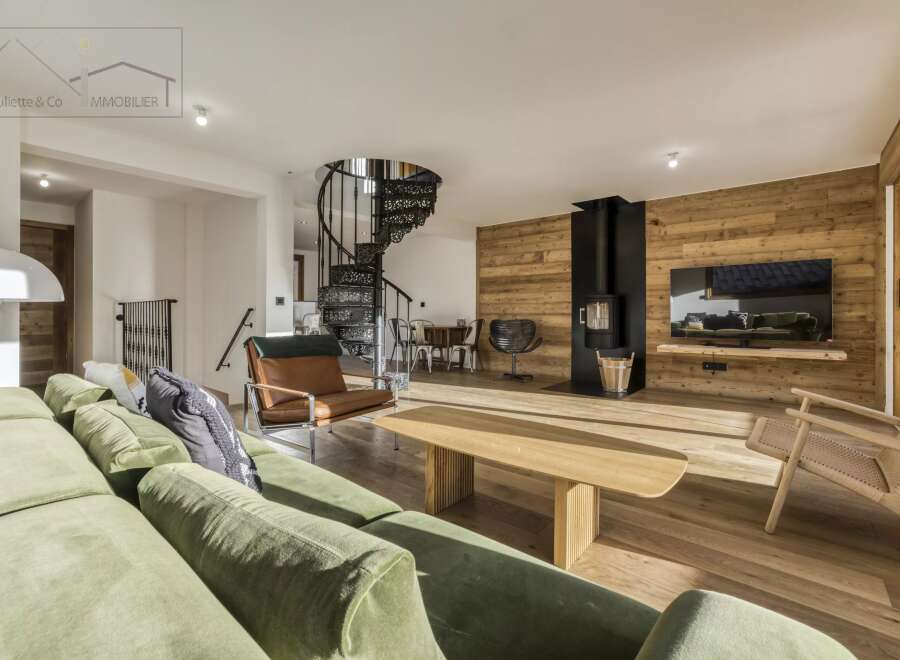 Experience luxury living in this stunning property featuring a spiral staircase and a cozy fireplace.