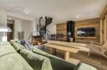 Experience luxury living in this stunning property featuring a spiral staircase and a cozy fireplace.
