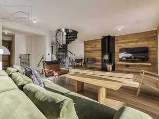 Experience luxury living in this stunning property featuring a spiral staircase and a cozy fireplace.