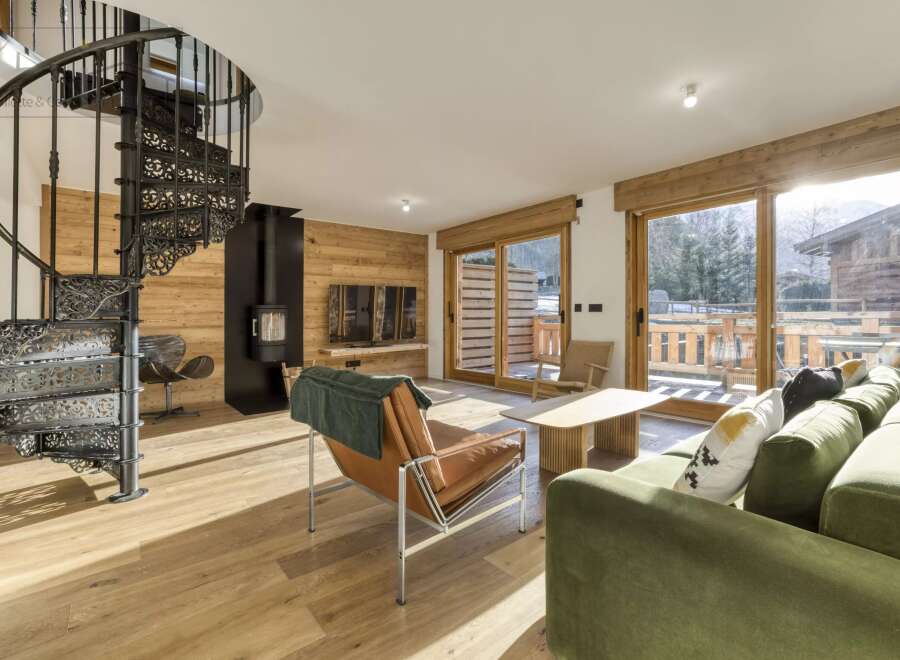 Step into luxury with this stunning property featuring a unique spiral staircase and a cozy fireplace.
