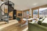 Step into luxury with this stunning property featuring a unique spiral staircase and a cozy fireplace.