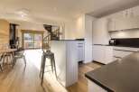 Discover the epitome of modern living in this stunning property, featuring a sleek kitchen with a stylish island and contemporary appliances.